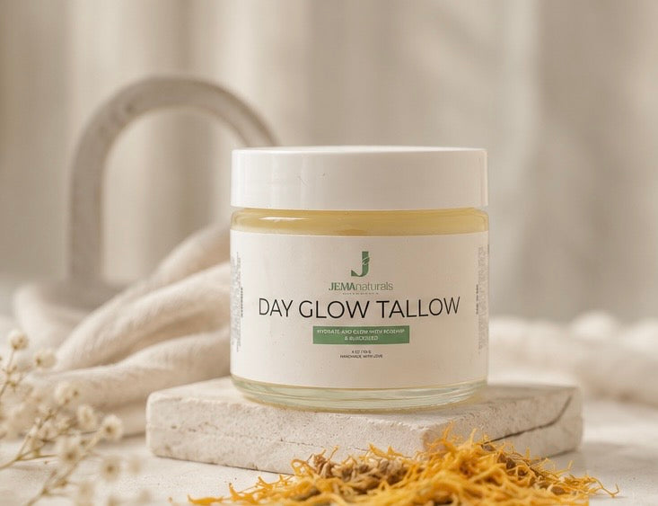 A jar of Jemanaturls Day Glow Tallow  face moisturizer sits on a stone block with dried tallow flowers in the foreground and a soft, neutral background.